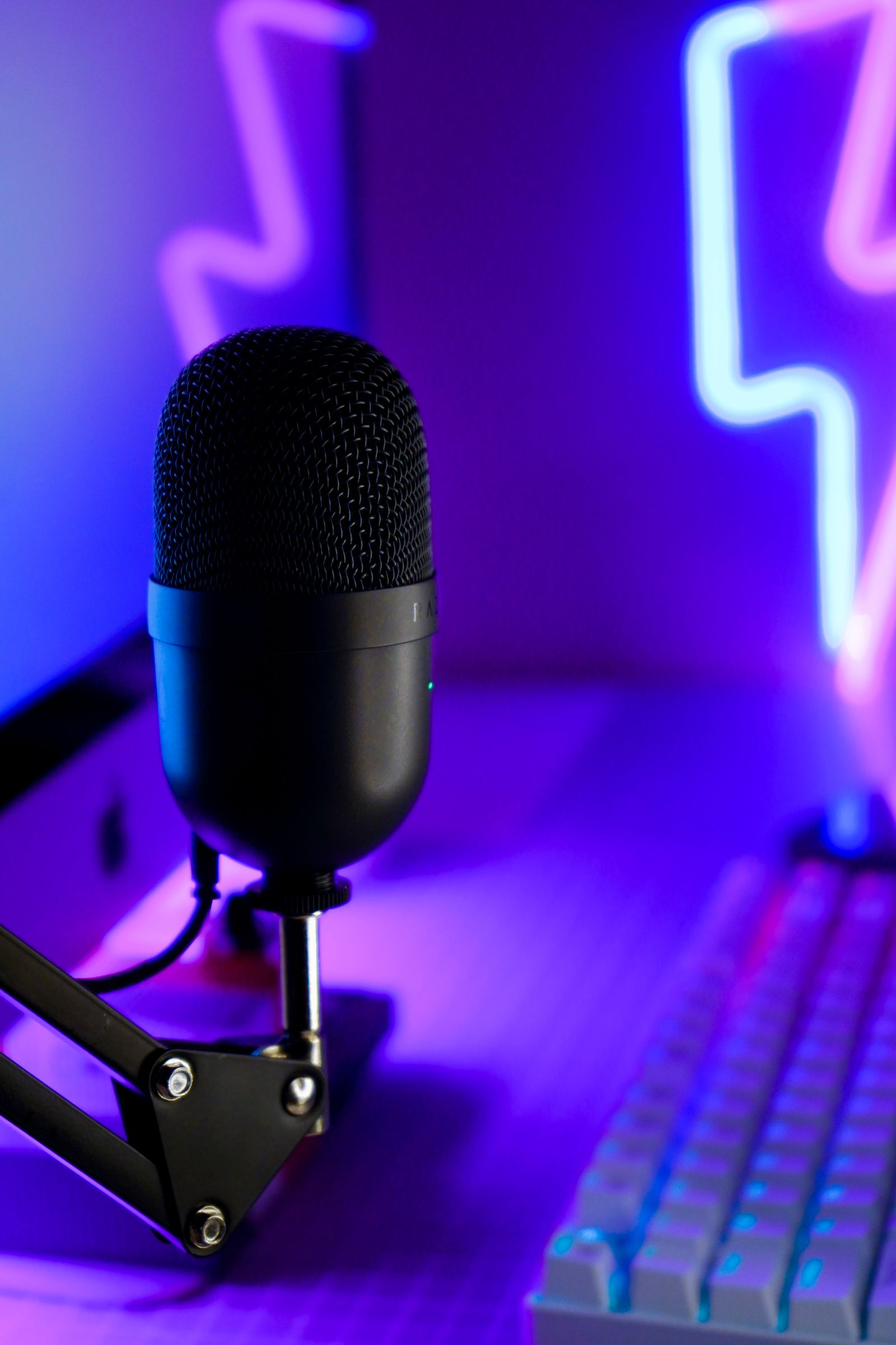 A host recording an episode of the Muskeg Signal podcast at a desk with a microphone and headphones